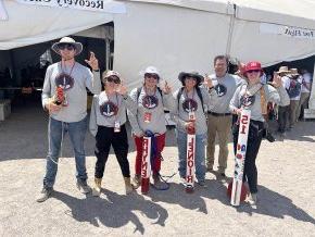 Rocket team making sign of the bear at Spaceport America