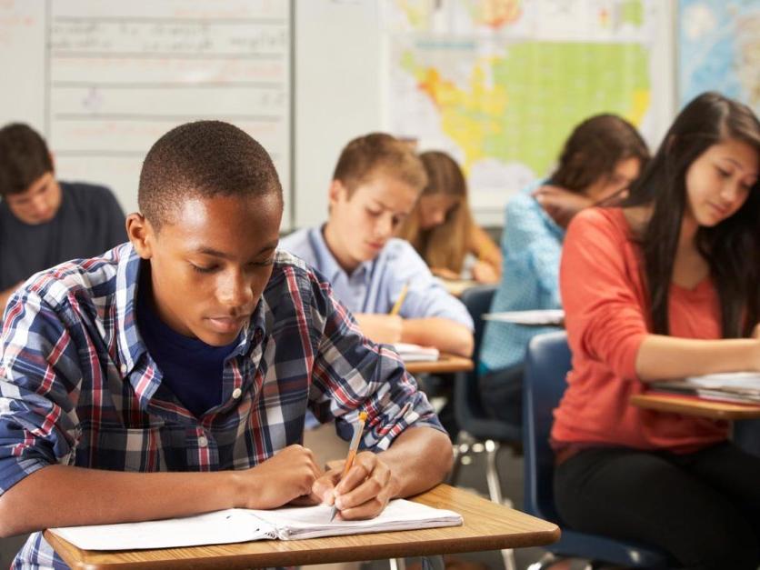 High school students working at desks in classroom