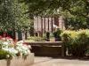 View of campus flowers and brick building in summer